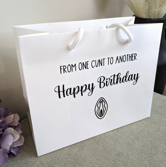 A White gift bag with a line art vagina and the wording from one cunt to another