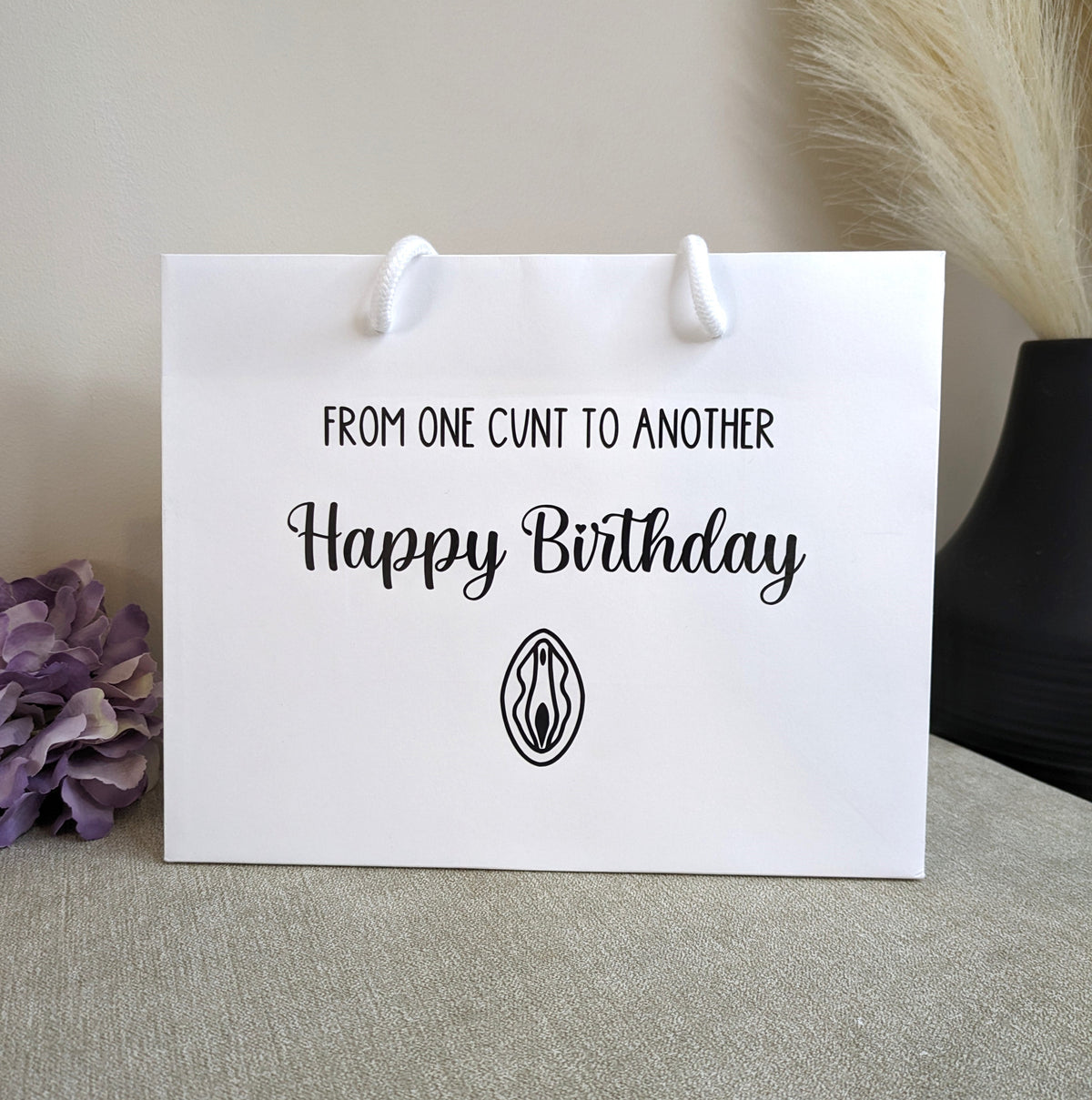 Luxury white rope birthday bag. With swearing in black writing.