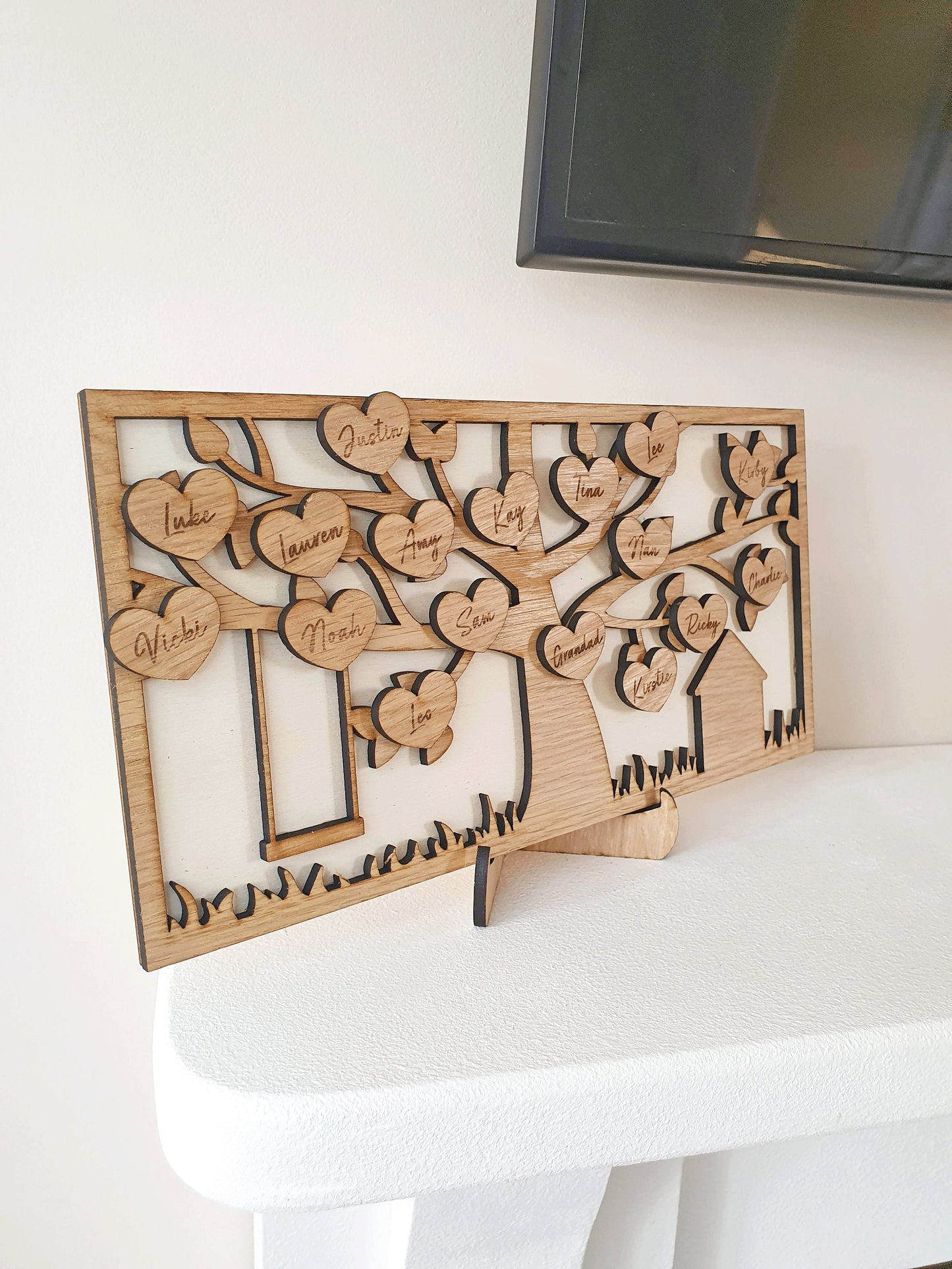 Oak wooden family tree on a fire place. Each family member is on a branch. The family tree is on a stand for easy movement