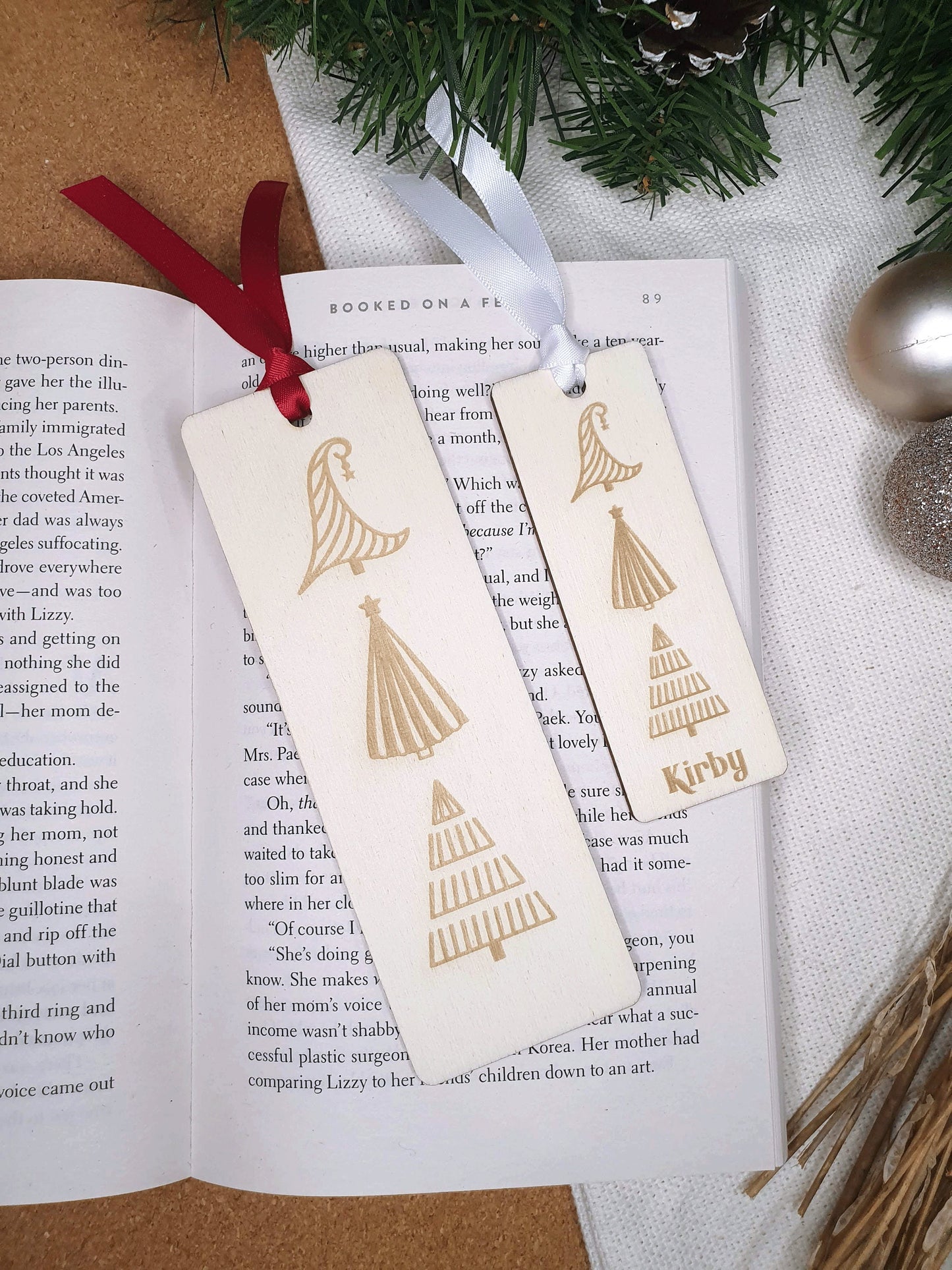 2 different Christmas bookmarks. One small with a personlaised name another large one with 3 modern christmas trees engraved.