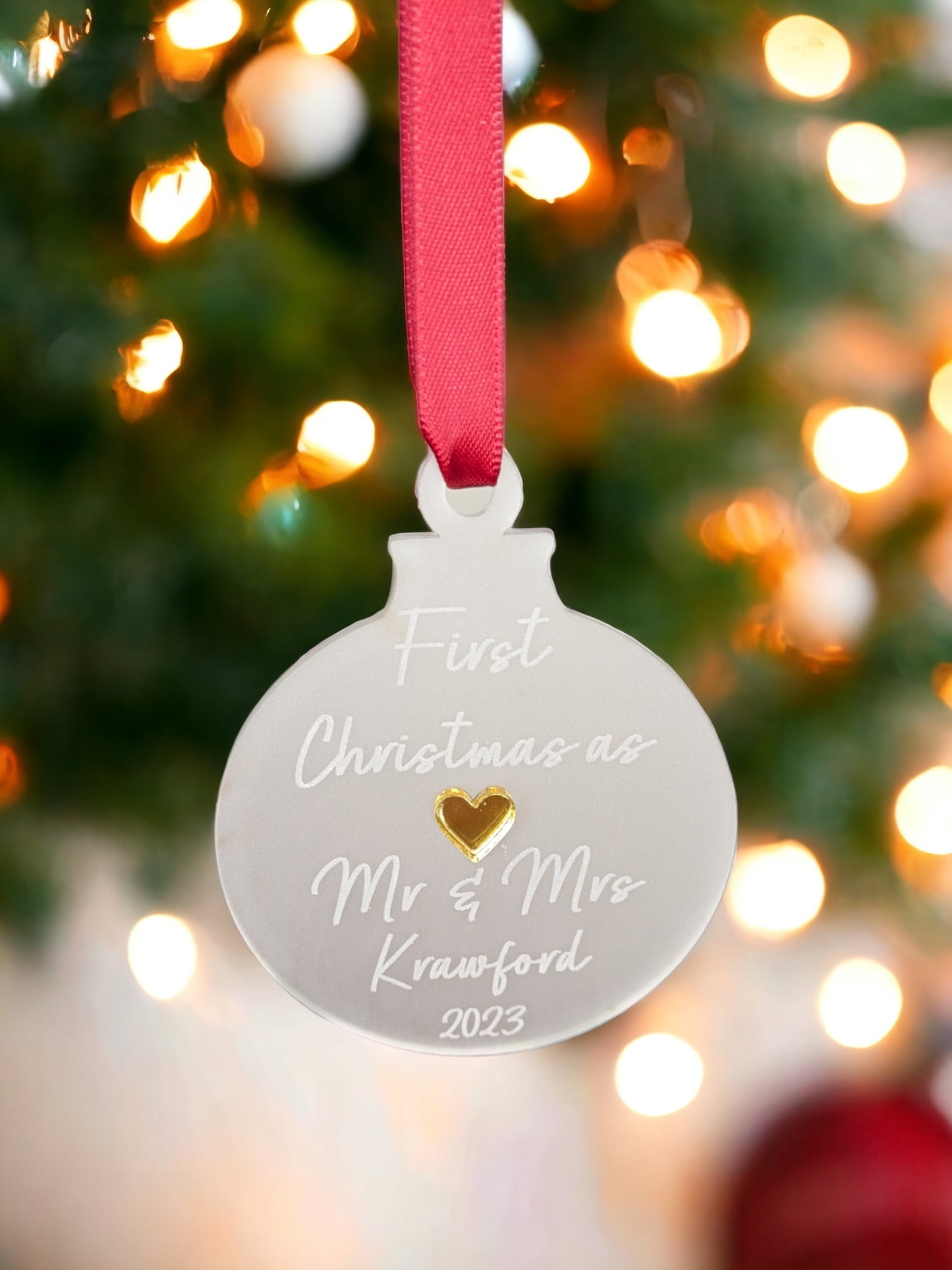 first christmas married bauble with red ribbon