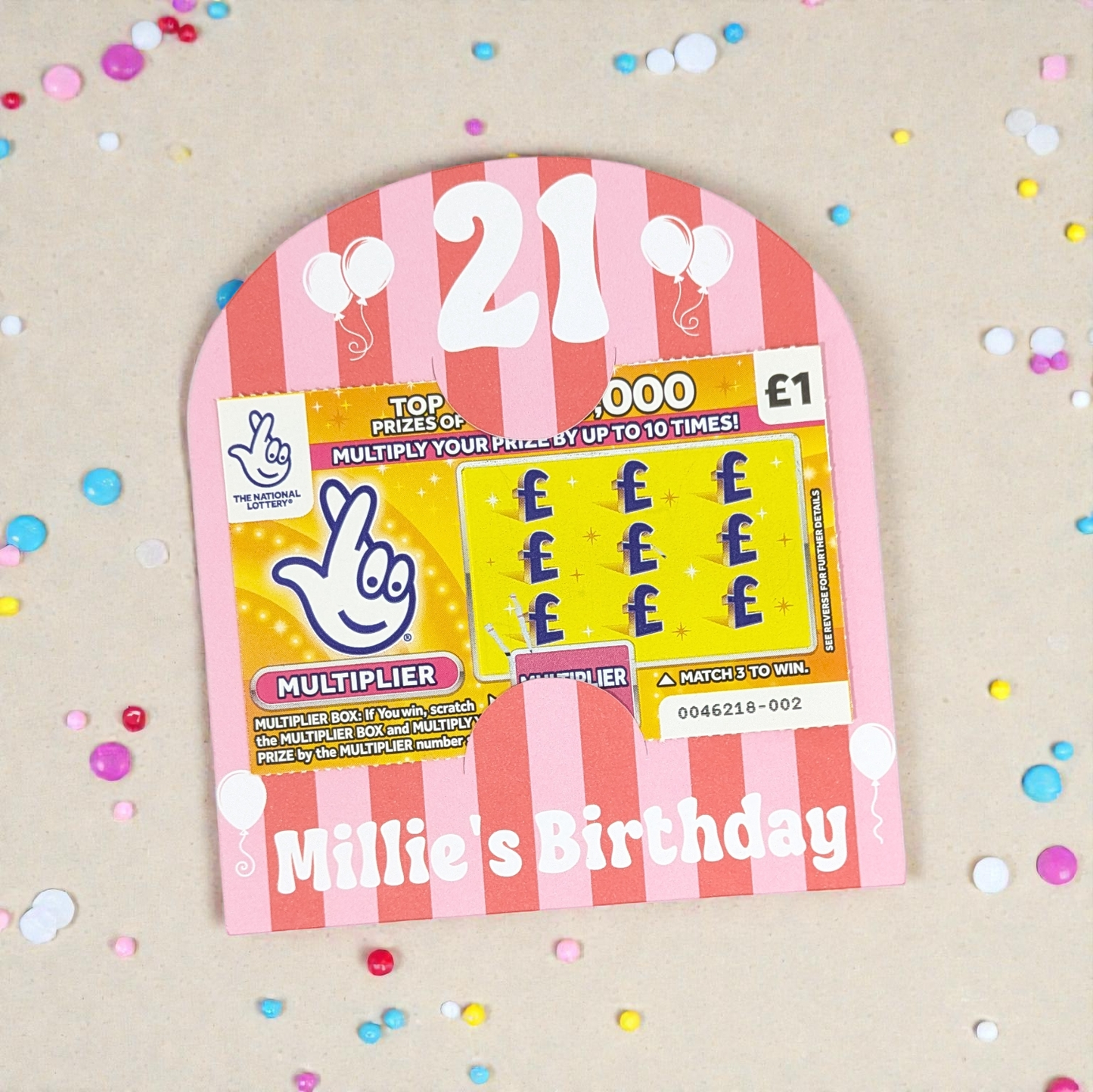 21st birthday party favour on a cream table with confetti around it.