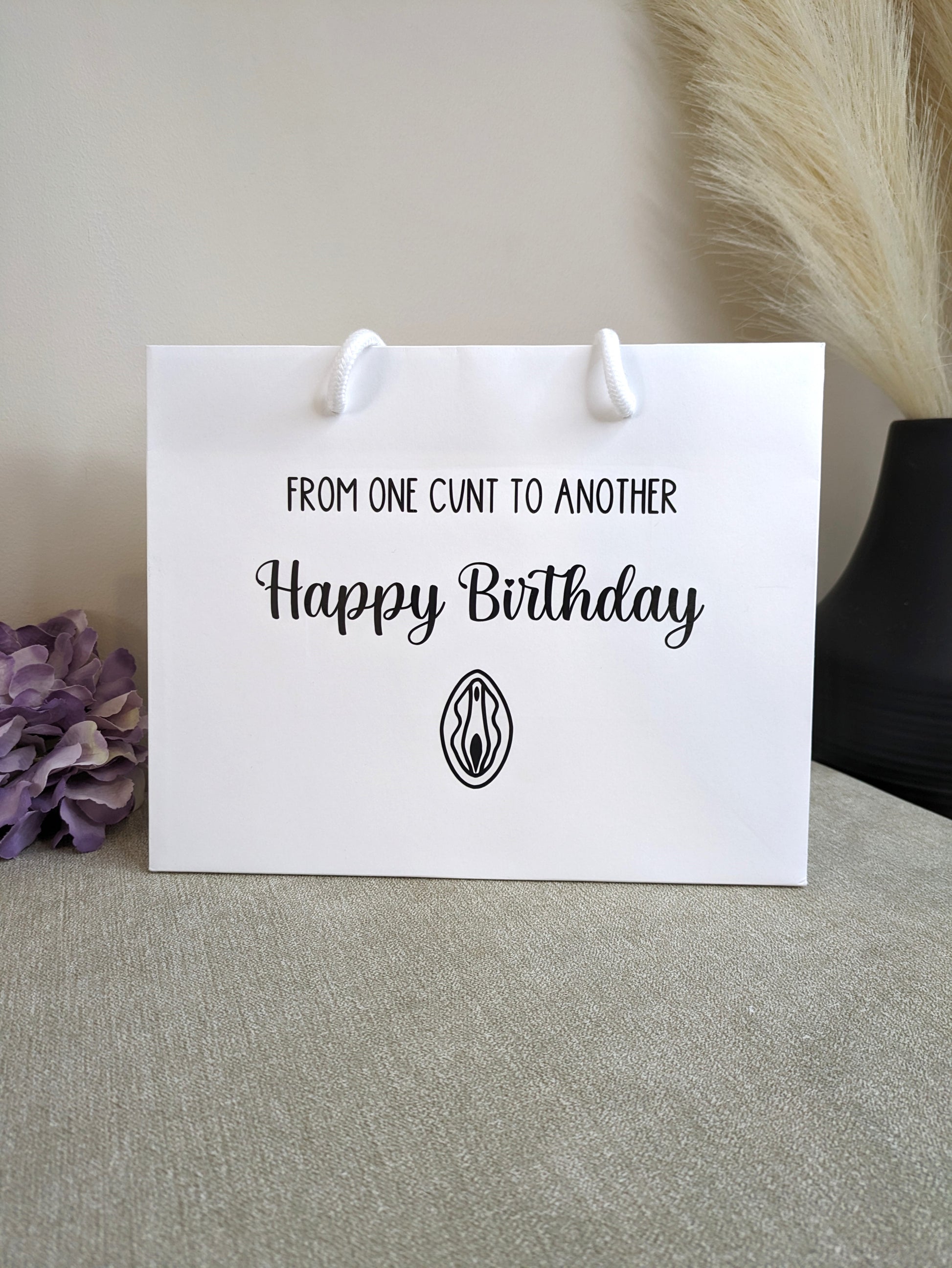 Luxury white rope birthday bag. With swearing in black writing.