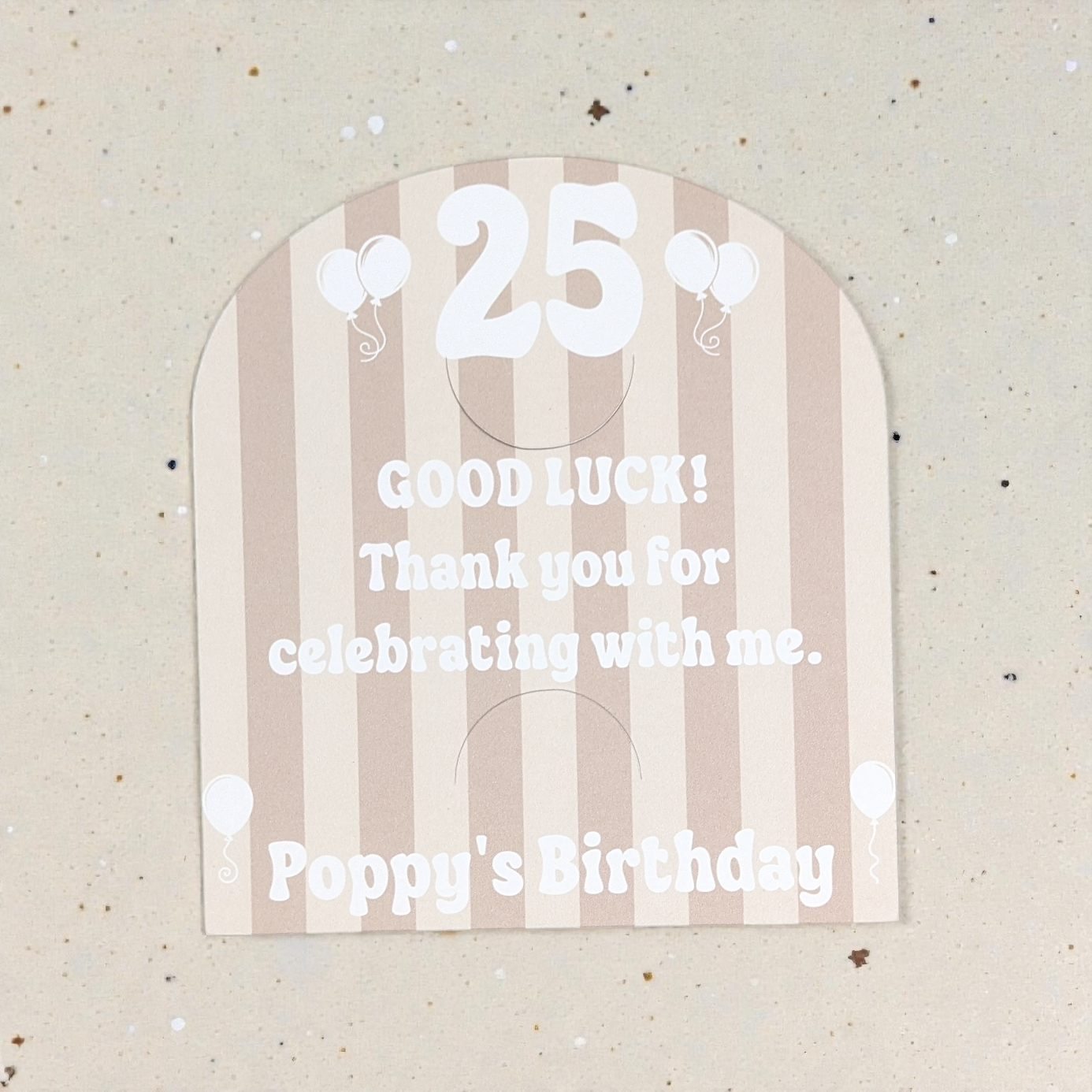 scratch card holder with '25 Good Luck! Thank you for celebrating with me. Poppy's Birthday' text on a striped background.