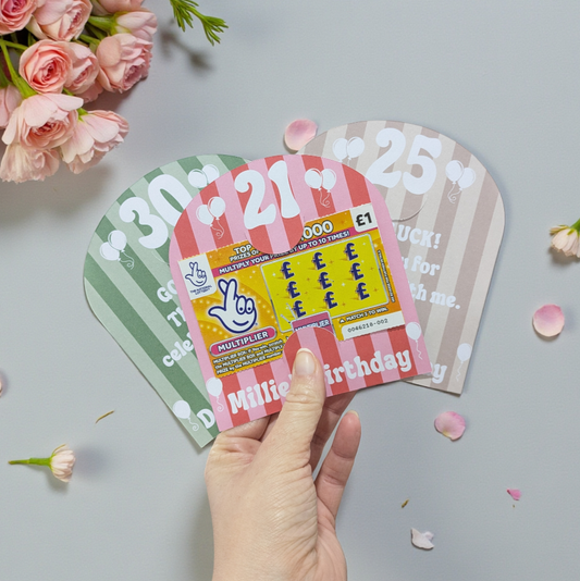 Hand holding birthday scratch card holders for a 21st birthday party