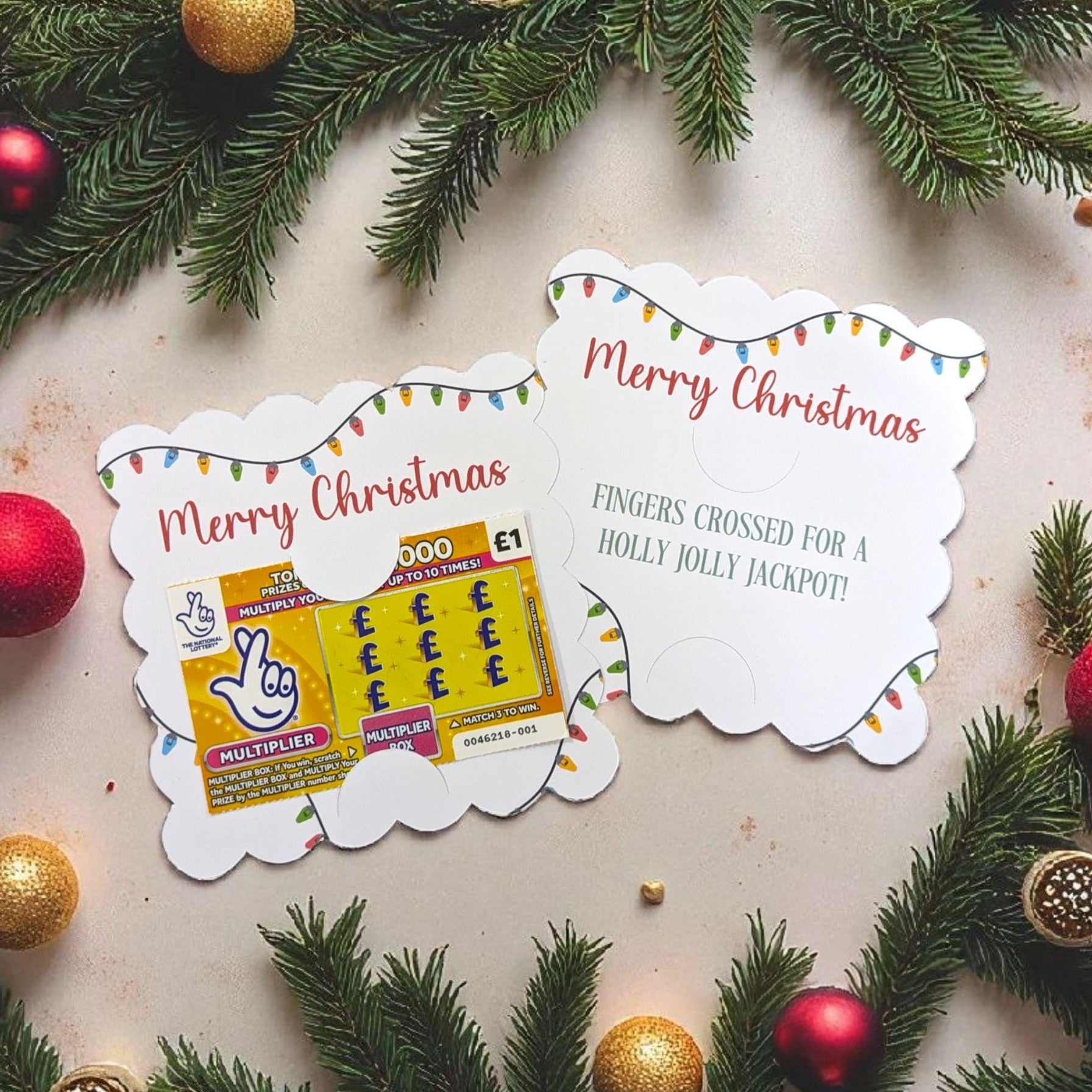 Two Christmas lottery tickets with festive decorations on a light background