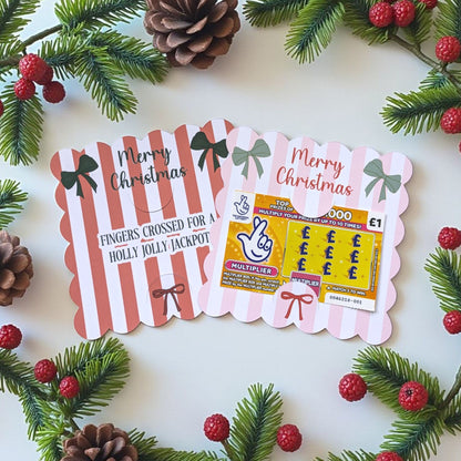 Two Christmas lottery tickets with scratch card holders with festive decorations on a white background