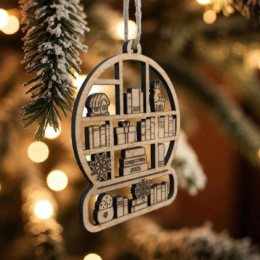 Wooden christmas ornament shaped like a bookshelf with books and decorative items, hanging on a Christmas tree.