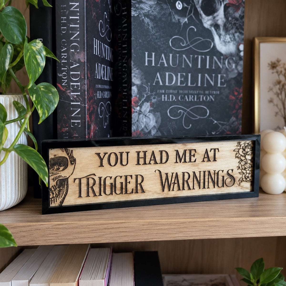 You had me at trigger warnings bookshelf sign