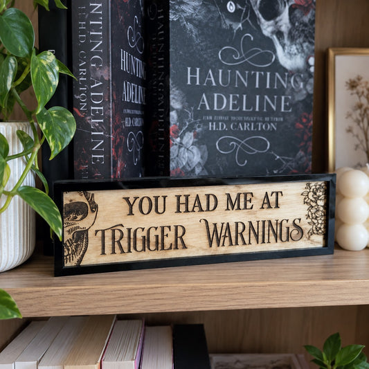 You had me at trigger warnings bookshelf sign