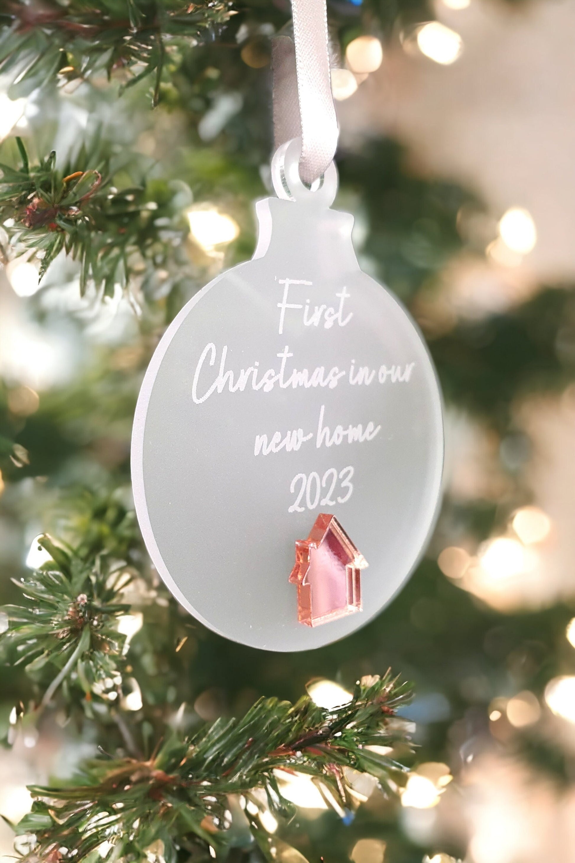 frosted acrylic bauble with a rose gold house. 