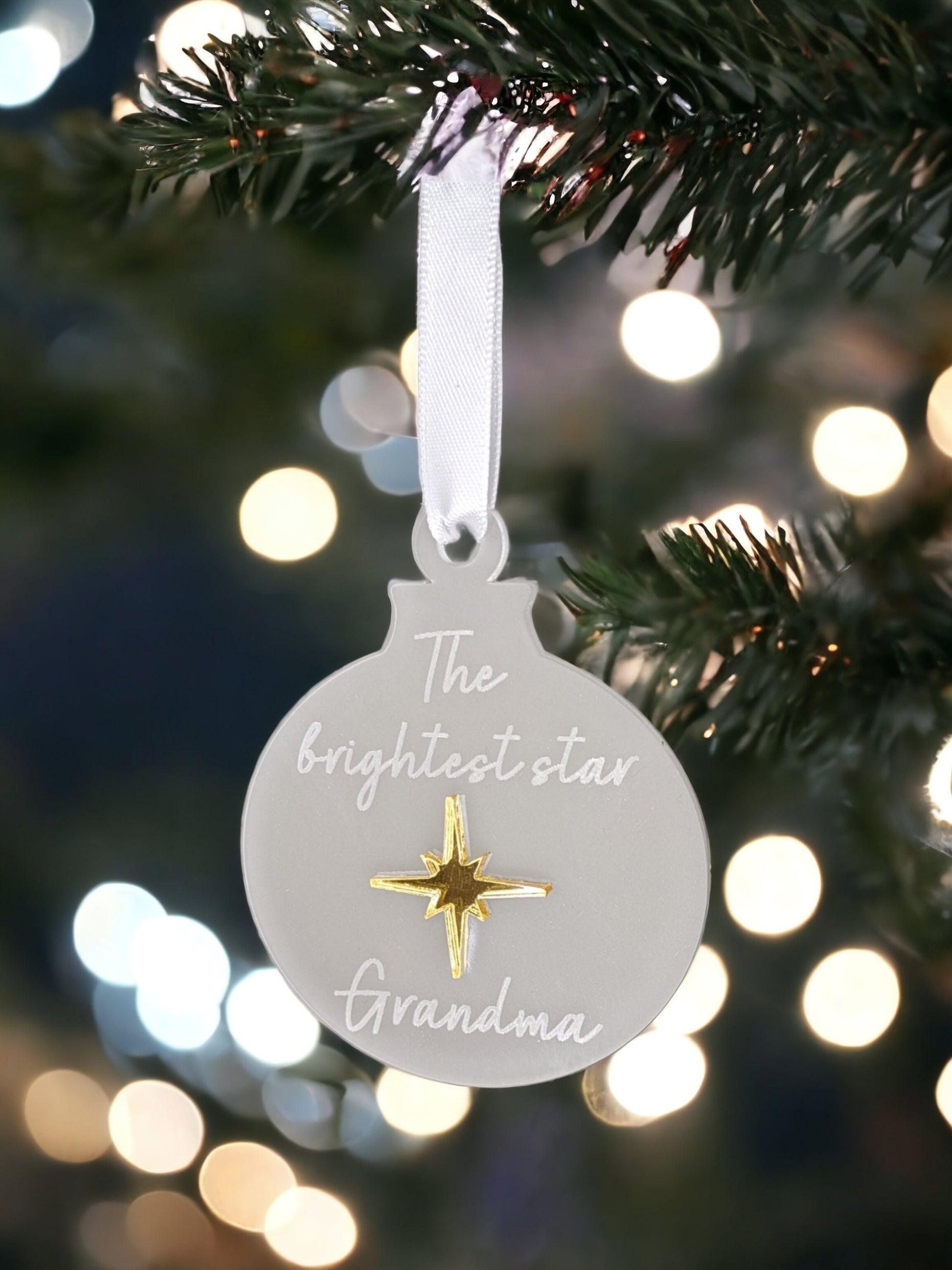 A grandma memorial bauble made with a gold star and white ribbon.