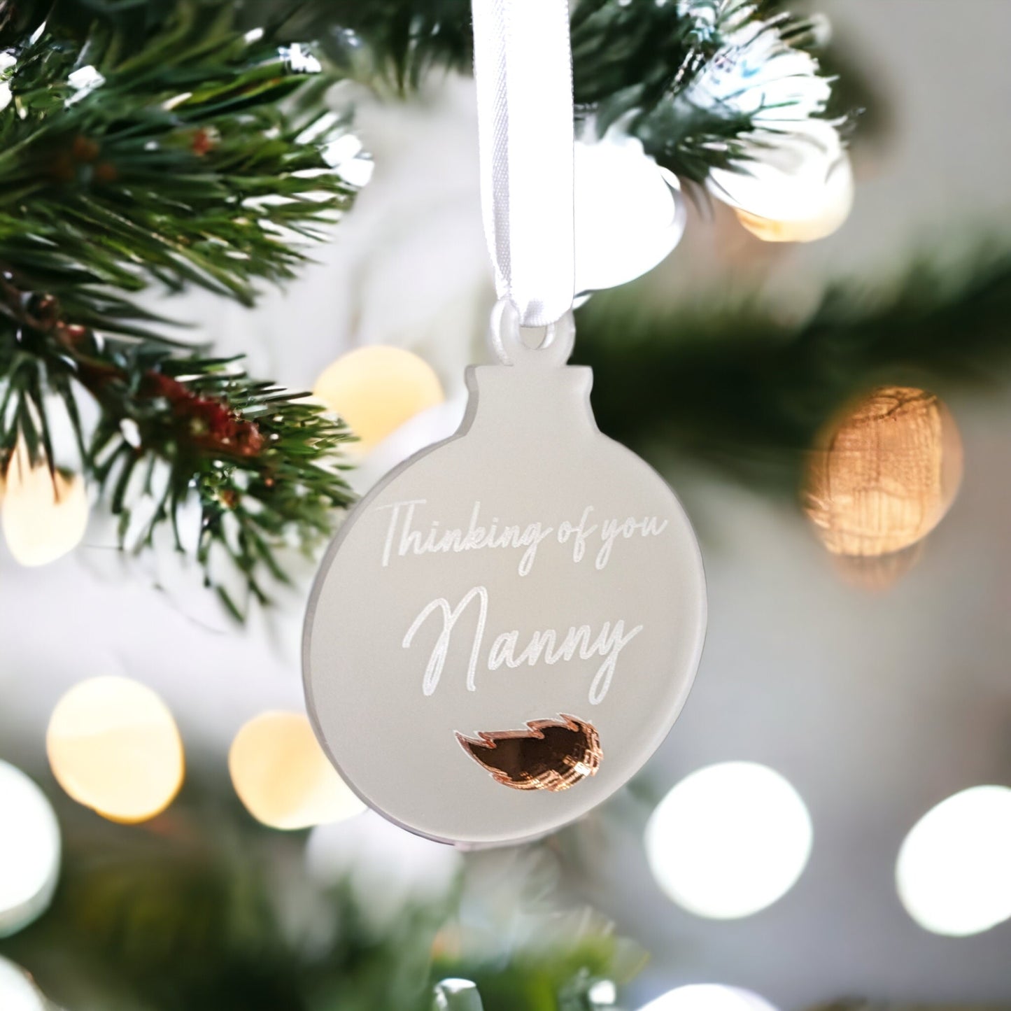 Memorial bauble with a rose gold freather. Thinking of you nanny is engraved in to the acrylic Christmas bauble