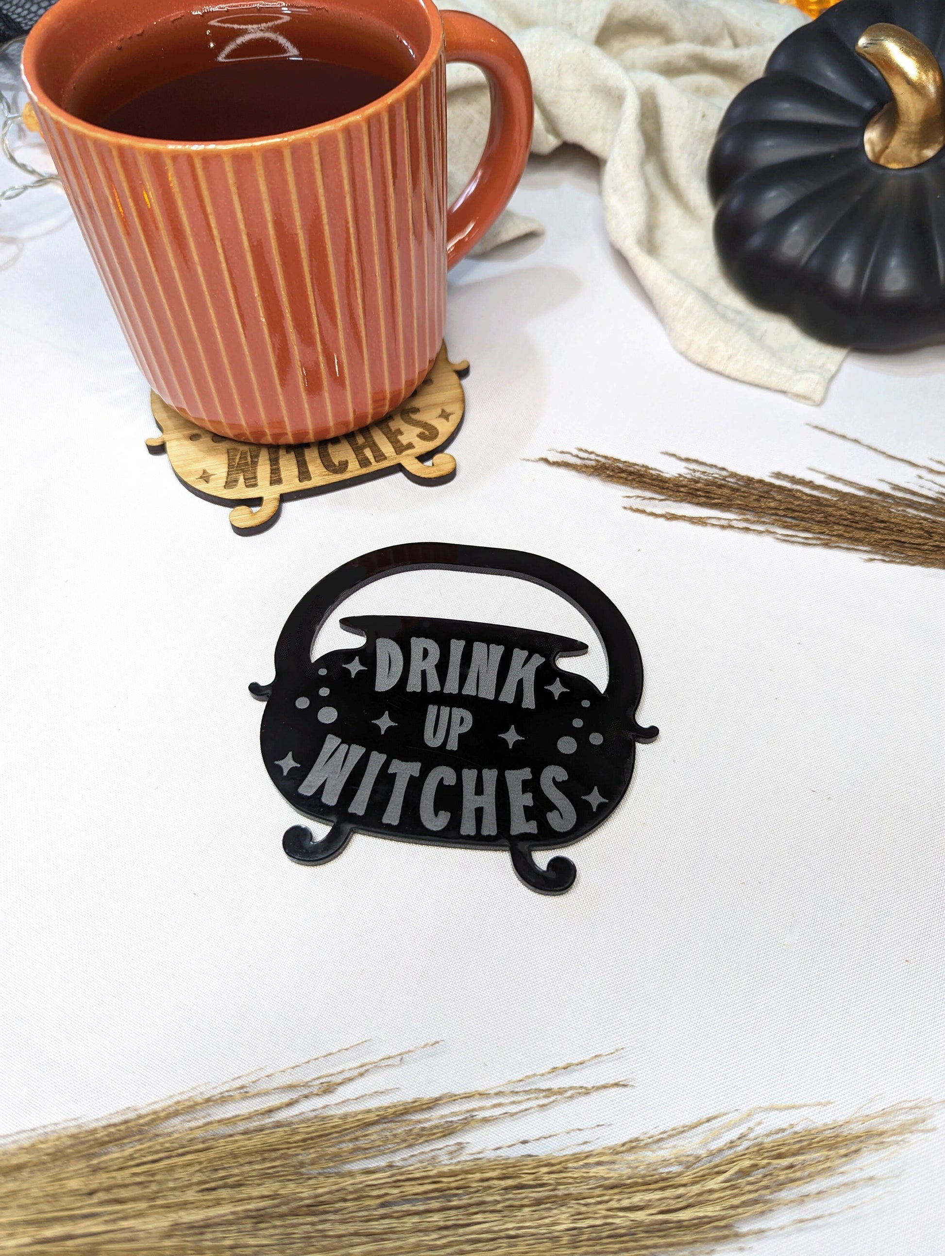 cauldron shaped home decor coaster. Drink up witches is engraved in to the acrylic coaster