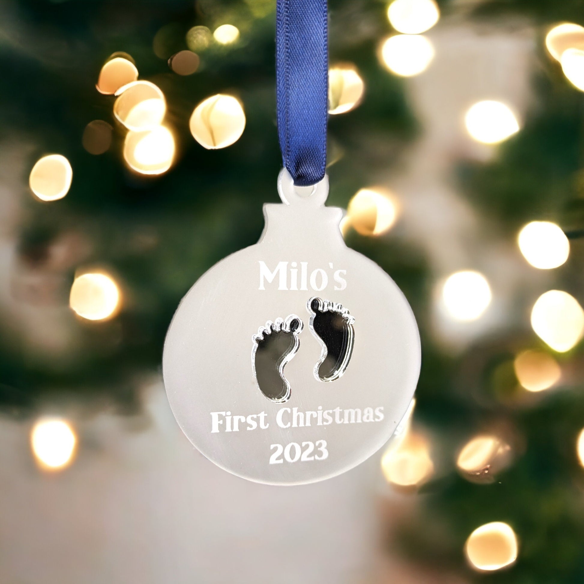 A hanging decoration with baby first christmas engraved.