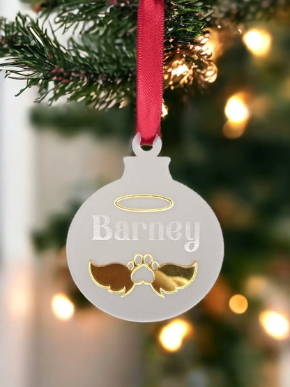 a hanging frosted acrylic pet bauble. With memorial pet angel wings and halo. The pets name is engraved in to the christmas ornament with red ribbon