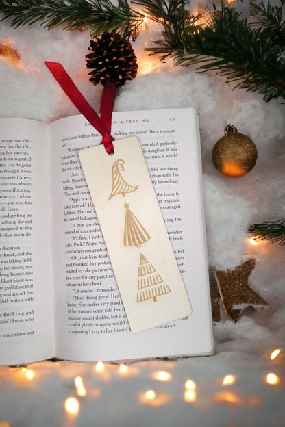 Wooden engraved bookmark with 3 different Christmas tree designs. Red ribbon attached at the top for easy page keeping. 