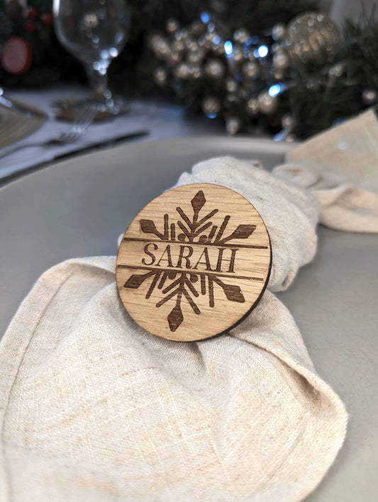 winter wonderland inspired woodn table name for a christmas dinner. Made with wood and has the name sarah engraved in the middle of the snow flake.
