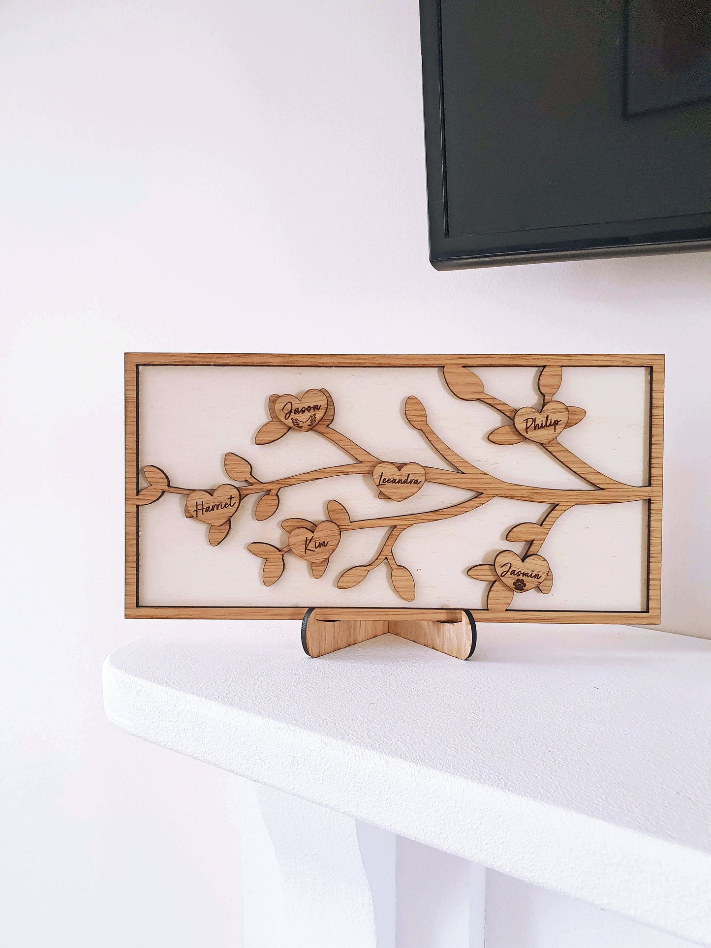 Wooden family tree with 6 different family members. Made with oak wood on a delicate branch and leaf design. Angel wings and paw prints are on some family members.