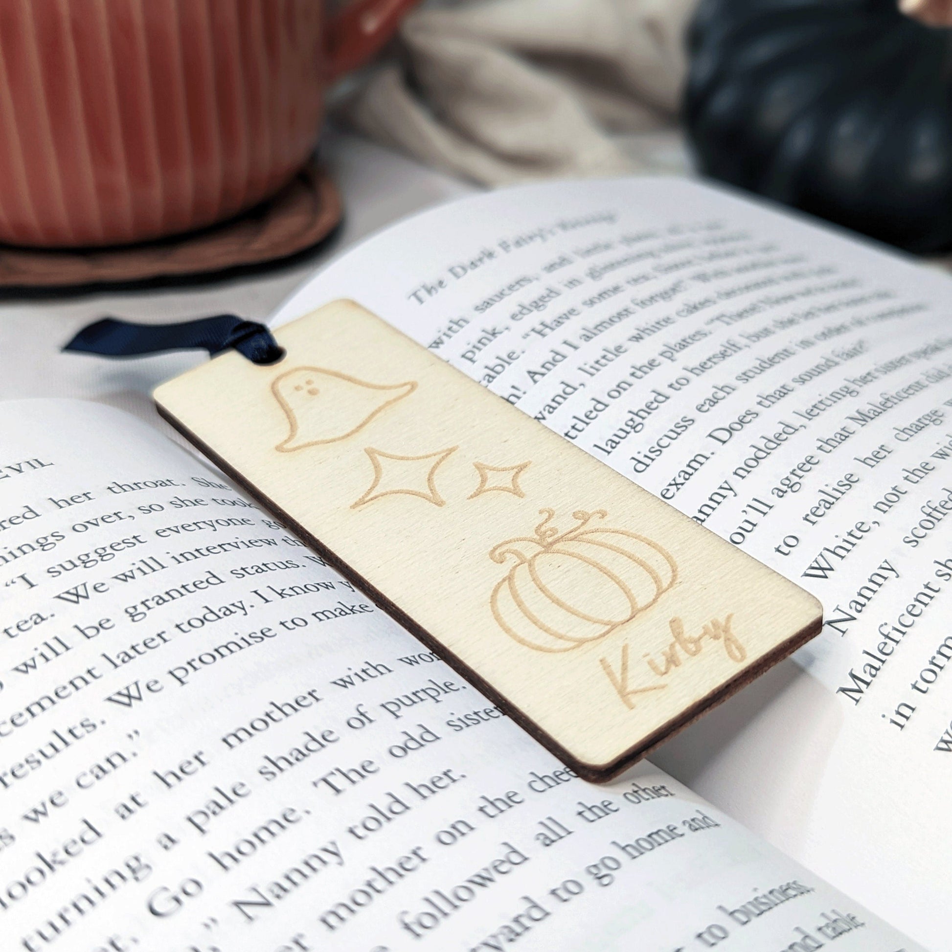 A small wood bookmark with engraved halloween details