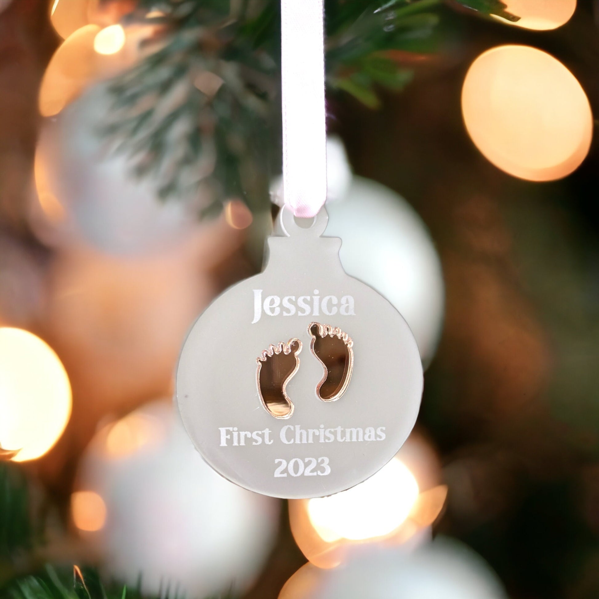 acrylic bauble with rose gold baby feet. Engraved