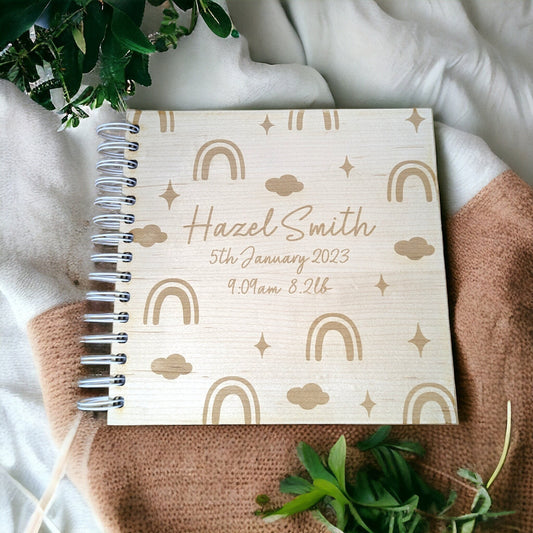 a wooden photo album with rainbows and clours engraved. Personalised with the babies name. 