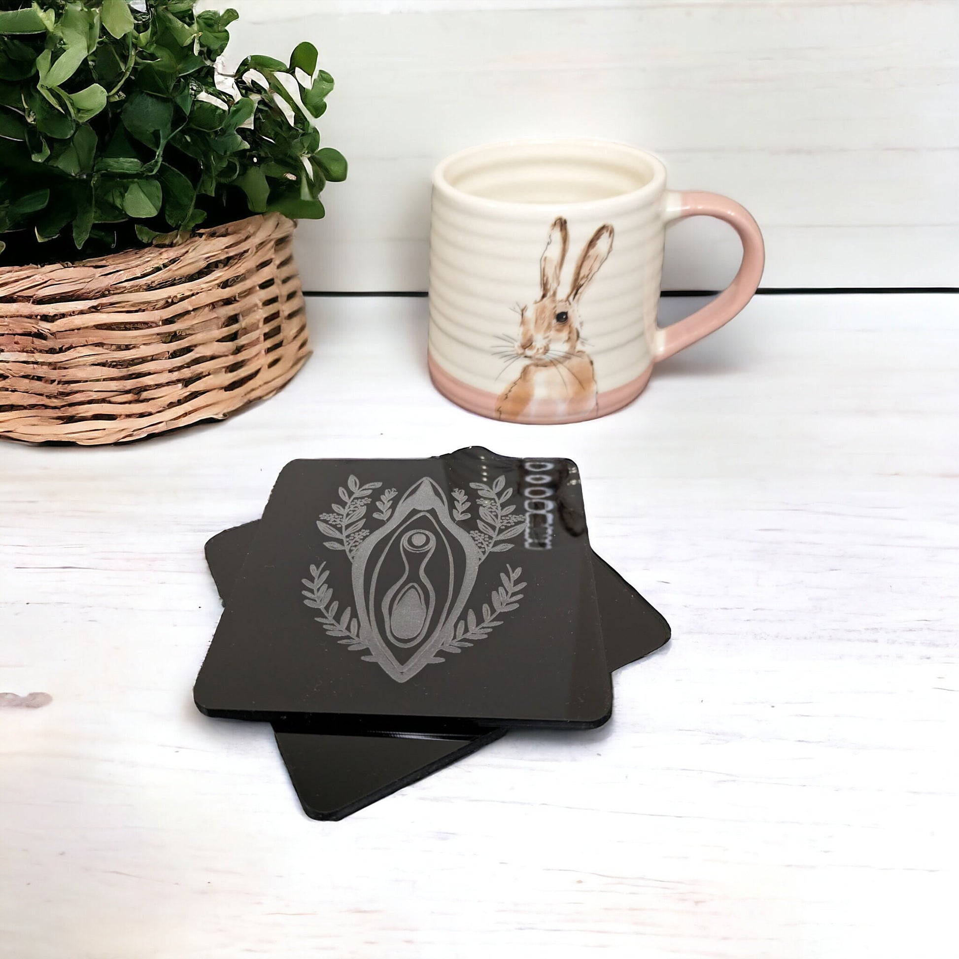Stack of 2 vagina shaped coasters. With a foliage design behind the vulva. Beautiful vulva themed home gift